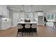 Bright open kitchen with a center island and barstool seating flowing into the dining area at 3785 Pilgrim Mill Rd, Cumming, GA 30041