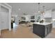 Bright open-concept living room with hardwood floors, fireplace and kitchen with island at 3785 Pilgrim Mill Rd, Cumming, GA 30041