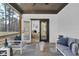 Inviting screened porch with comfortable seating and a view into the Primary bedroom at 3785 Pilgrim Mill Rd, Cumming, GA 30041