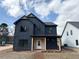 Striking two-story home showcasing navy siding, gabled roof, and a welcoming covered front porch at 42 Puckett Se Rd, Emerson, GA 30137