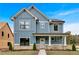 Charming two-story home with a welcoming front porch, blue siding, and white trim, set against a bright blue sky at 42 Puckett Se Rd, Emerson, GA 30137