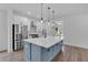 Modern kitchen with blue island, white cabinets, quartz countertops, and stainless steel appliances at 42 Puckett Se Rd, Emerson, GA 30137