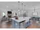 Open concept kitchen with blue island, white cabinets, and farmhouse sink, overlooking living room at 42 Puckett Se Rd, Emerson, GA 30137