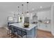 Virtually staged kitchen with blue island, white cabinets, and stainless steel appliances at 42 Puckett Se Rd, Emerson, GA 30137