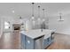 Open concept kitchen with blue island, white cabinets, and farmhouse sink, overlooking living room at 42 Puckett Se Rd, Emerson, GA 30137