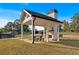 Relaxing outdoor covered patio with fireplace and picnic table at 42 Puckett Se Rd, Emerson, GA 30137