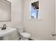 Simple and elegant bathroom with a pedestal sink and toilet at 314 Cornett Way, Lawrenceville, GA 30046