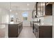 Modern kitchen with granite countertops and dark cabinets at 314 Cornett Way, Lawrenceville, GA 30046