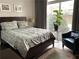 Cozy bedroom with a large window, wood floors, decorative plants, and stylish furniture at 2479 Peachtree Ne Rd # 105, Atlanta, GA 30305