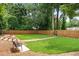 Grassy dog park with benches and a walkway surrounded by a wood fence, ideal for pet owners at 2479 Peachtree Ne Rd # 105, Atlanta, GA 30305