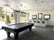 A sleek game room includes a pool table, bar seating, and bright natural light, perfect for entertaining at 2479 Peachtree Ne Rd # 105, Atlanta, GA 30305