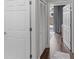 Bright hallway featuring hardwood floors, white doors, and a glimpse of natural light at 2479 Peachtree Ne Rd # 105, Atlanta, GA 30305