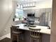 Modern kitchen features stainless steel appliances, gray cabinetry, a backsplash, and a quartz countertop at 2479 Peachtree Ne Rd # 105, Atlanta, GA 30305