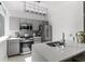 The modern kitchen is accented with stainless steel appliances, gray cabinets, and a quartz countertop at 2479 Peachtree Ne Rd # 105, Atlanta, GA 30305