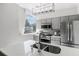 Modern kitchen features stainless steel appliances, gray cabinetry, a backsplash, and a quartz countertop at 2479 Peachtree Ne Rd # 105, Atlanta, GA 30305