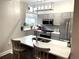 Modern kitchen features stainless steel appliances, gray cabinetry, a backsplash, and a quartz countertop at 2479 Peachtree Ne Rd # 105, Atlanta, GA 30305