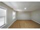 Unfinished basement with neutral walls and floors, and two windows at 1079 Bar Harbor Pl, Lawrenceville, GA 30044