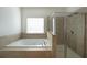 Relaxing bathroom with a large soaking tub and walk-in shower at 1079 Bar Harbor Pl, Lawrenceville, GA 30044