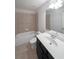 Clean bathroom with a shower/tub combo and dark vanity at 1079 Bar Harbor Pl, Lawrenceville, GA 30044