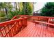 Red wooden deck with steps leading down to yard at 1079 Bar Harbor Pl, Lawrenceville, GA 30044