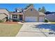 Brick house with a three-car garage and landscaped yard at 1079 Bar Harbor Pl, Lawrenceville, GA 30044