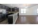 Modern kitchen featuring dark cabinetry and granite countertops at 1079 Bar Harbor Pl, Lawrenceville, GA 30044