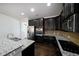 Modern kitchen with dark cabinetry and granite countertops at 1079 Bar Harbor Pl, Lawrenceville, GA 30044