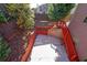 Concrete patio with wooden retaining wall and deck access at 1079 Bar Harbor Pl, Lawrenceville, GA 30044