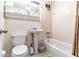 Clean bathroom with a pedestal sink, shower/tub combo, and tile surround at 215 Piedmont Ne Ave # 502, Atlanta, GA 30308