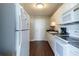 Efficient kitchen with white cabinets and appliances at 215 Piedmont Ne Ave # 502, Atlanta, GA 30308