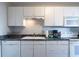 White kitchen cabinets, countertops, and appliances at 215 Piedmont Ne Ave # 502, Atlanta, GA 30308