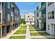 Exterior view between modern townhomes with grass and a garage at 1641 Mcnaught Dr # 35, Atlanta, GA 30317