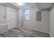 Finished basement room with grey walls, wood-look flooring, and exterior access at 1204 Westridge Sw Rd, Atlanta, GA 30311