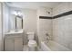 Basement bathroom with grey vanity, tiled shower, and tub at 1204 Westridge Sw Rd, Atlanta, GA 30311