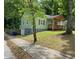 Side view of the home featuring a quaint porch and lush green lawn at 1204 Westridge Sw Rd, Atlanta, GA 30311