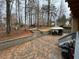 Backyard with brick patio, gazebo, steps, and a play area amidst the trees at 1621 Telfair Chase Way, Lawrenceville, GA 30043