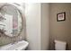 Small powder room with decorative mirror and single sink at 1979 Spivey Village Dr, Jonesboro, GA 30236