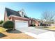 Two-car garage with a long driveway and neatly trimmed landscaping at 1979 Spivey Village Dr, Jonesboro, GA 30236
