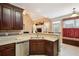 Kitchen with dark wood cabinets, granite countertops and a window seat at 1979 Spivey Village Dr, Jonesboro, GA 30236