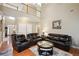 Two-story living room with leather sofas and a high ceiling at 1979 Spivey Village Dr, Jonesboro, GA 30236