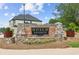 Attractive stone entrance sign for Hosch Reserve community against backdrop of lush landscaping and blue sky at 4025 Hosch Reserve Dr, Buford, GA 30519