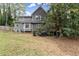 A well-maintained backyard with trees and a patio. The deck is also visible at 4250 Edgewater Nw Ct, Kennesaw, GA 30144