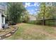 Grassy backyard with landscaping and trees. The deck and back of the house are also visible at 4250 Edgewater Nw Ct, Kennesaw, GA 30144