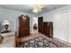 A cozy bedroom with a decorative rug, wooden dressers, and white closet doors at 4250 Edgewater Nw Ct, Kennesaw, GA 30144