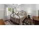 Charming bedroom with hardwood floors, large windows, and an ornate metal bed frame at 4250 Edgewater Nw Ct, Kennesaw, GA 30144