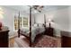 Bedroom with carpet, ceiling fan and a four-poster bed bathed in light at 4250 Edgewater Nw Ct, Kennesaw, GA 30144