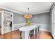 Dining room with an oval white table, modern pendant lighting, and hardwood floors at 4250 Edgewater Nw Ct, Kennesaw, GA 30144