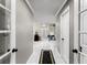 Hallway with white tile floors and neutral paint leading to the bright and airy bathroom at 4250 Edgewater Nw Ct, Kennesaw, GA 30144