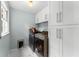 Well-lit laundry room with front-loading washer and dryer, cabinets, and tile flooring at 4250 Edgewater Nw Ct, Kennesaw, GA 30144