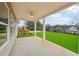 Covered back patio with ceiling fan, overlooking a fenced backyard at 1461 Stephens View Dr, Loganville, GA 30052